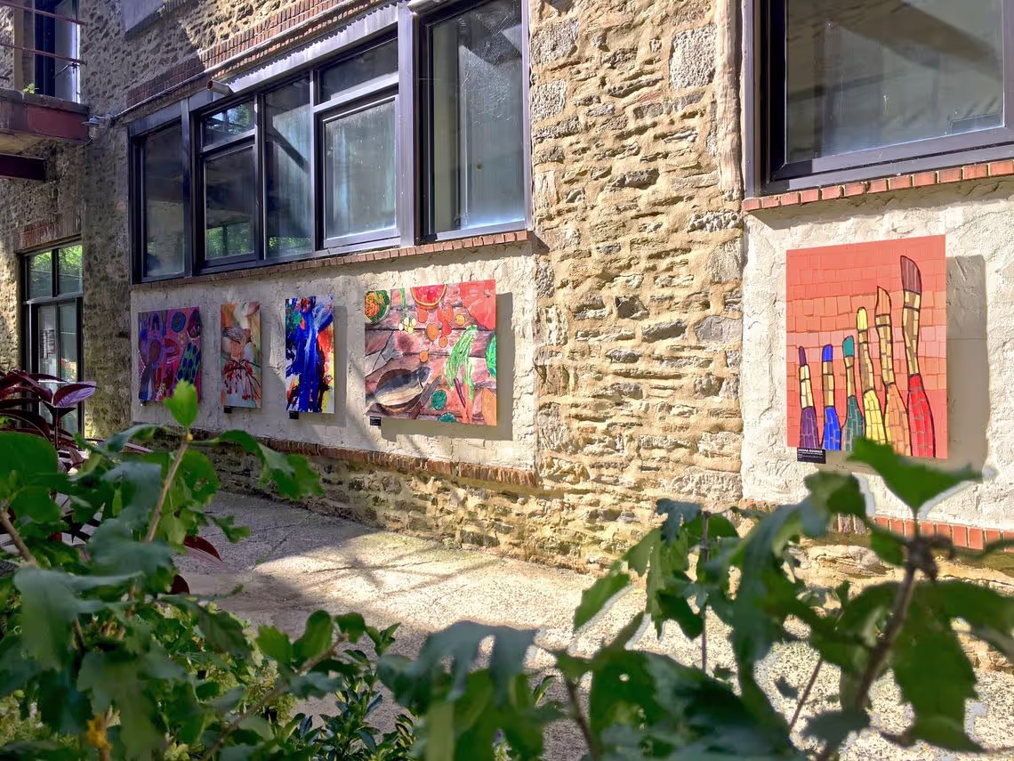 A building with a bunch of paintings on the side of it